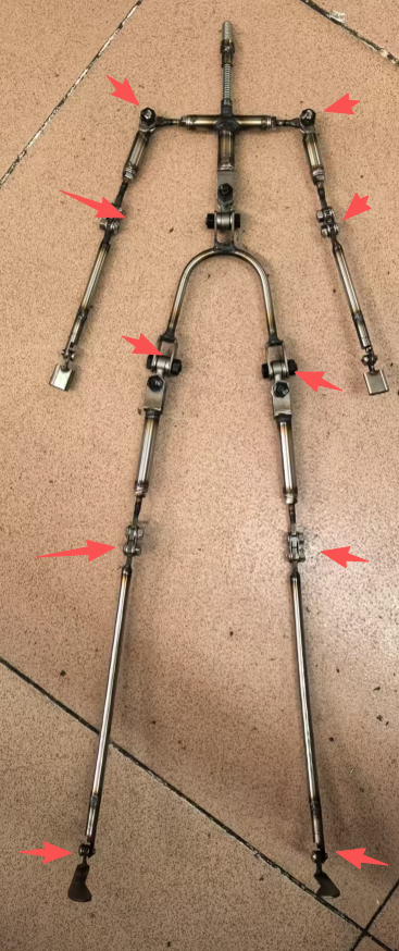 Alloy doll skeleton with red arrows marking each posable joint