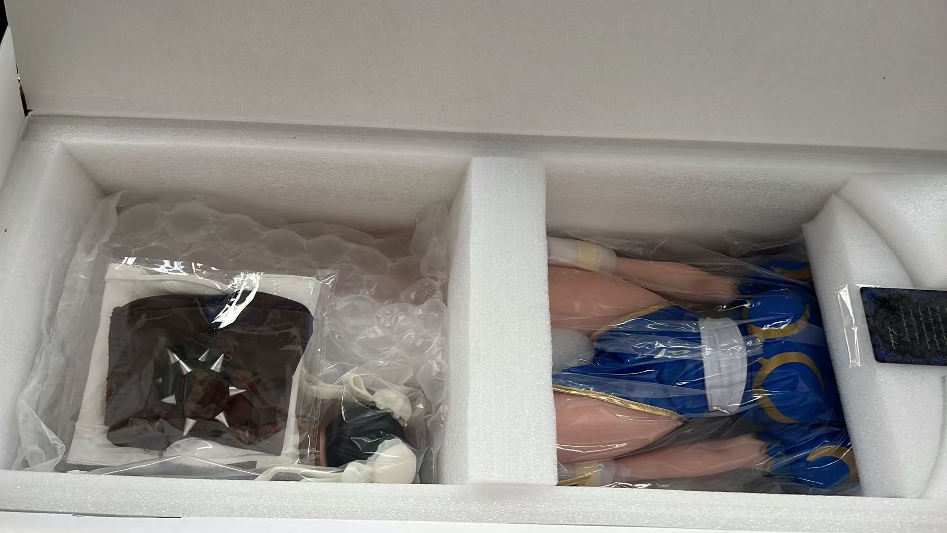 Chun-Li figure doll and accessories packed in separate foam compartments with the LORIBEAR anti-counterfeit card