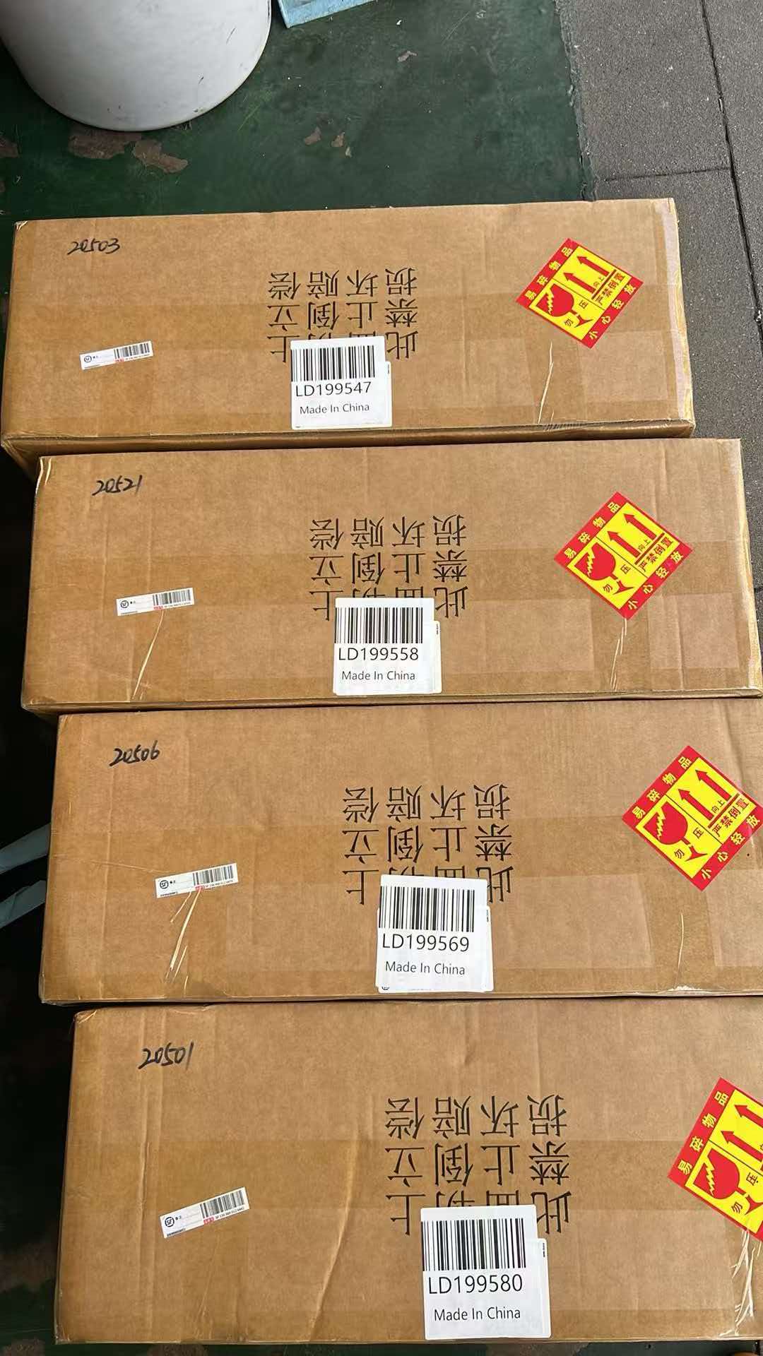 Plain brown LORIBEAR shipping cartons with only courier labels and handling stickers, no product information